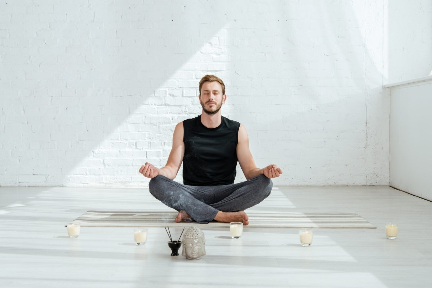 man sitting meditating in yoga studio.jpeg